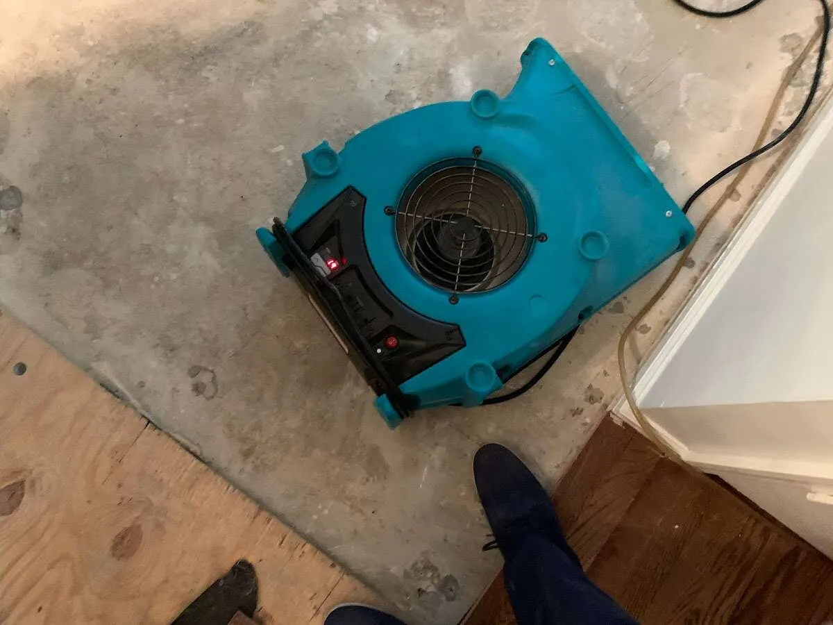 Air mover drying subfloor during Leak Detection & Repair in Bedford